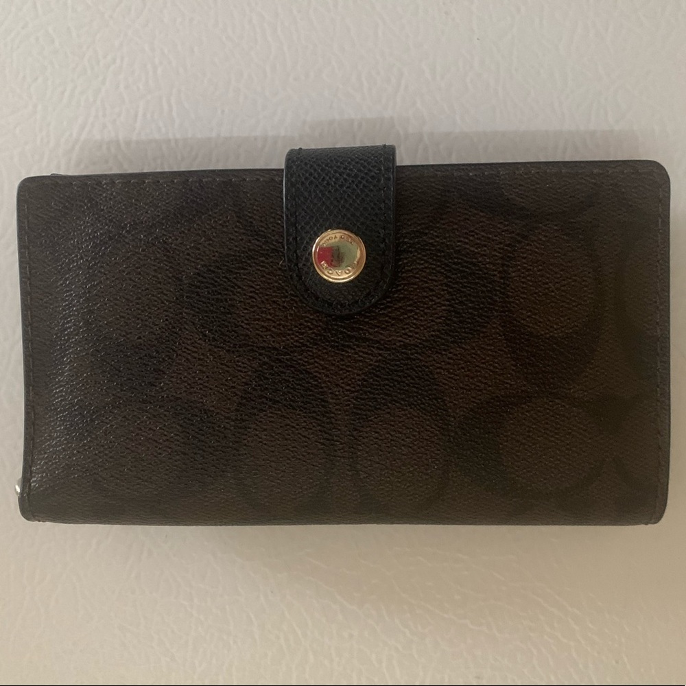 Woman’s brown coach wallet